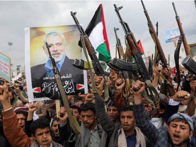 protesters mainly houthi supporters hold firearms next to a poster of assassinated hamas chief ismail haniyeh at the rally to show solidarity with palestinians in the gaza strip in sanaa yemen august 2 2024 photo reuters